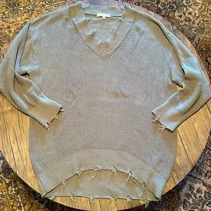 Cute cozy and trendy distressed v neck sweater
